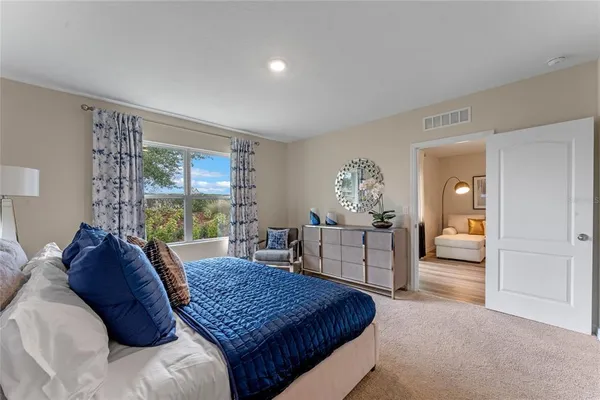 a living room with a bed furniture and a window