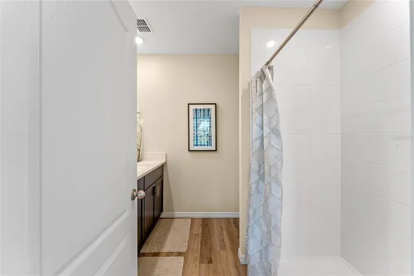 a view of a hallway with wooden floor and staircase