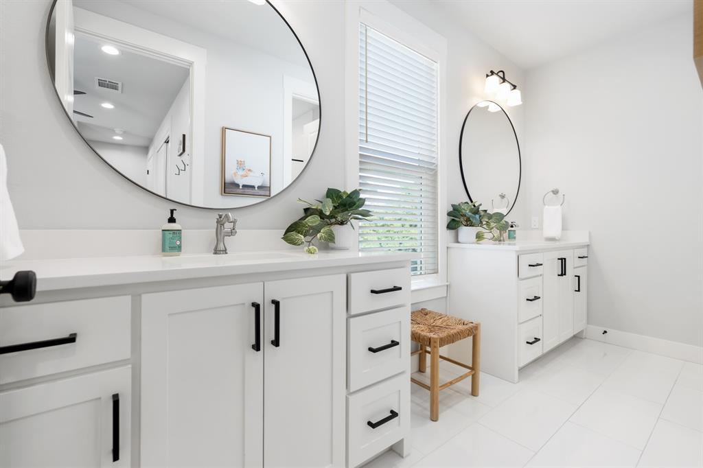 425 Proctor Avenue Waco, TX 76708 - Photo 23 of 33 wooden floor with white cabinets a sink and a mirror