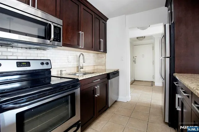 a kitchen with stainless steel appliances and cabinets