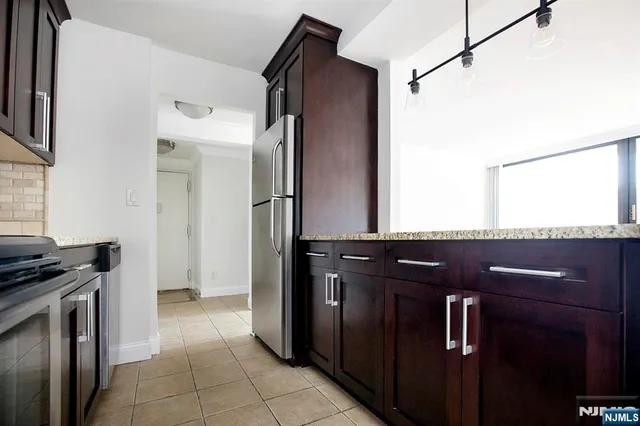 a kitchen with a refrigerator and a sink