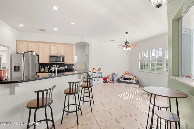 a view of a dining room with furniture and a chandelier