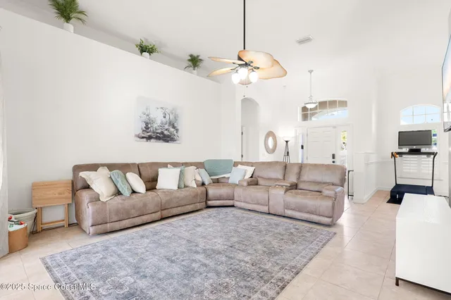 a living room with furniture chandelier and a couch