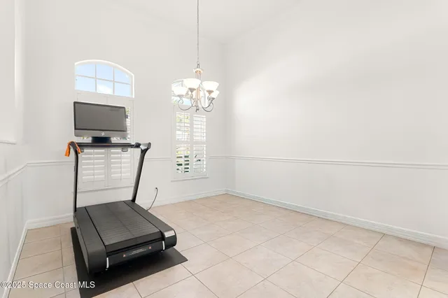 a room with gym equipment and a flat screen tv