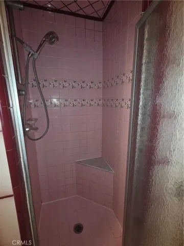 a bathroom with a glass shower door