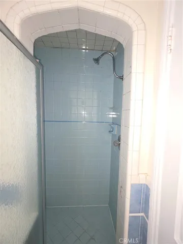 a bathroom with a glass shower door