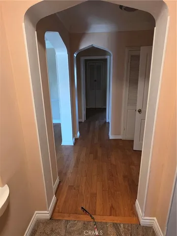 a view of a hallway with wooden floor