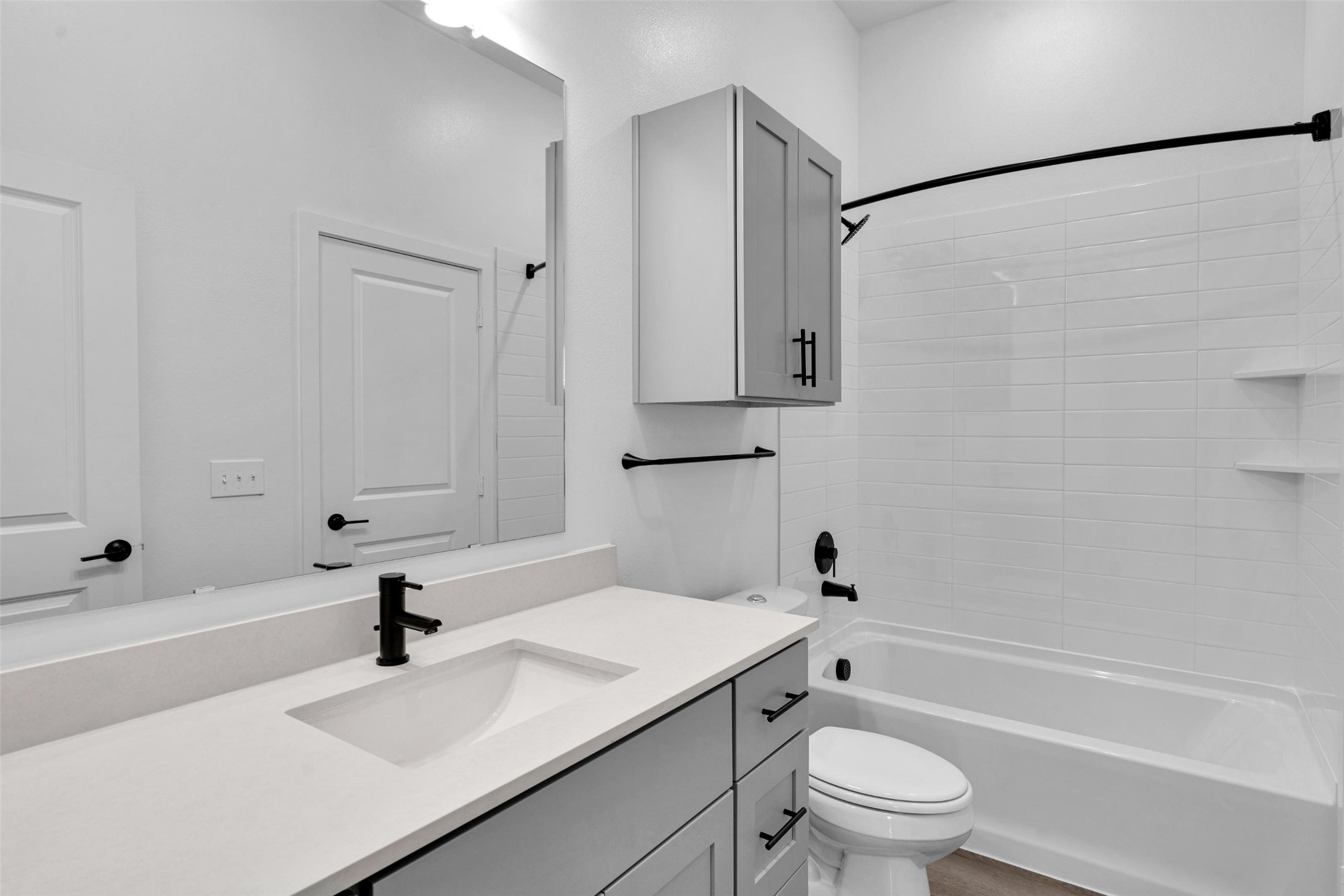 1584-326 Bernard Street Rowlett, TX 75089 - Photo 16 of 31 a bathroom with a sink toilet a mirror and shower