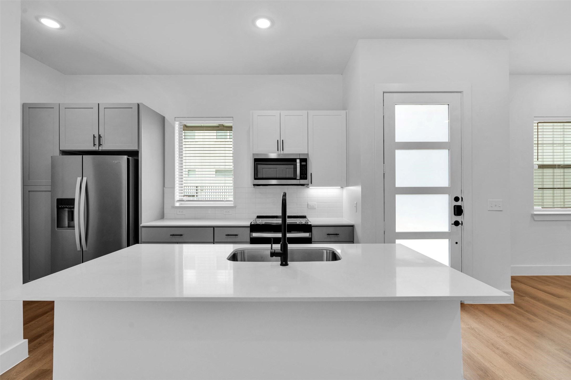 1584-326 Bernard Street Rowlett, TX 75089 - Photo 8 of 31 a kitchen with kitchen island a large counter top space appliances and a window