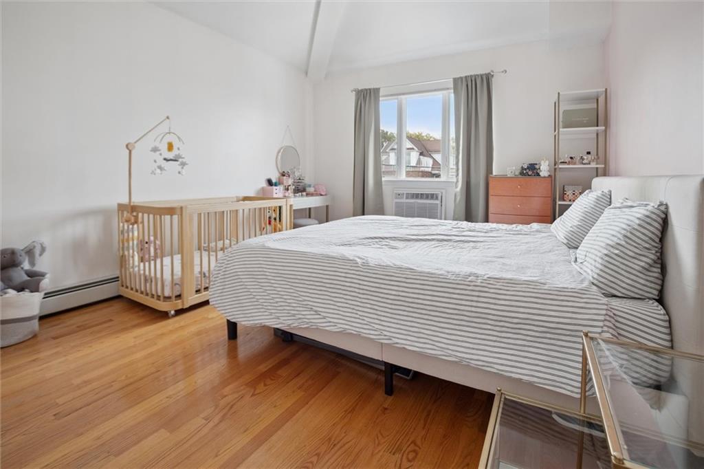 1523 74th Street, Unit 3F Brooklyn, NY 11228 - Photo 7 of 19 a bedroom with a bed and wooden floor