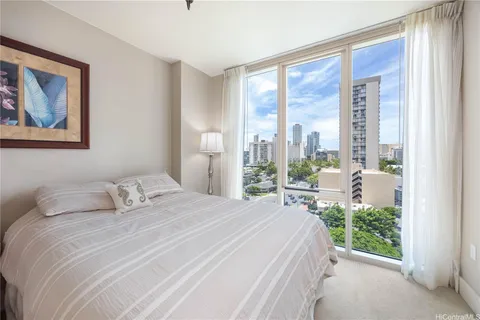 a bedroom with a large window and a bed