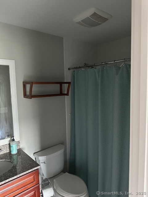 17 Vermont Avenue, Unit 17 Fairfield, CT 06824 - Photo 14 of 16 a white toilet sitting next to a bathroom sink