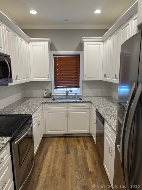 17 Vermont Avenue, Unit 17 Fairfield, CT 06824 - Photo 2 of 16 a kitchen with stainless steel appliances granite countertop a stove a sink and a refrigerator