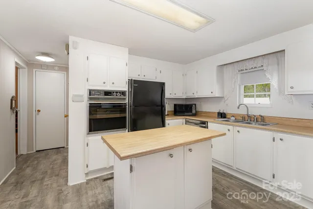 a kitchen with a sink a stove a refrigerator and a refrigerator