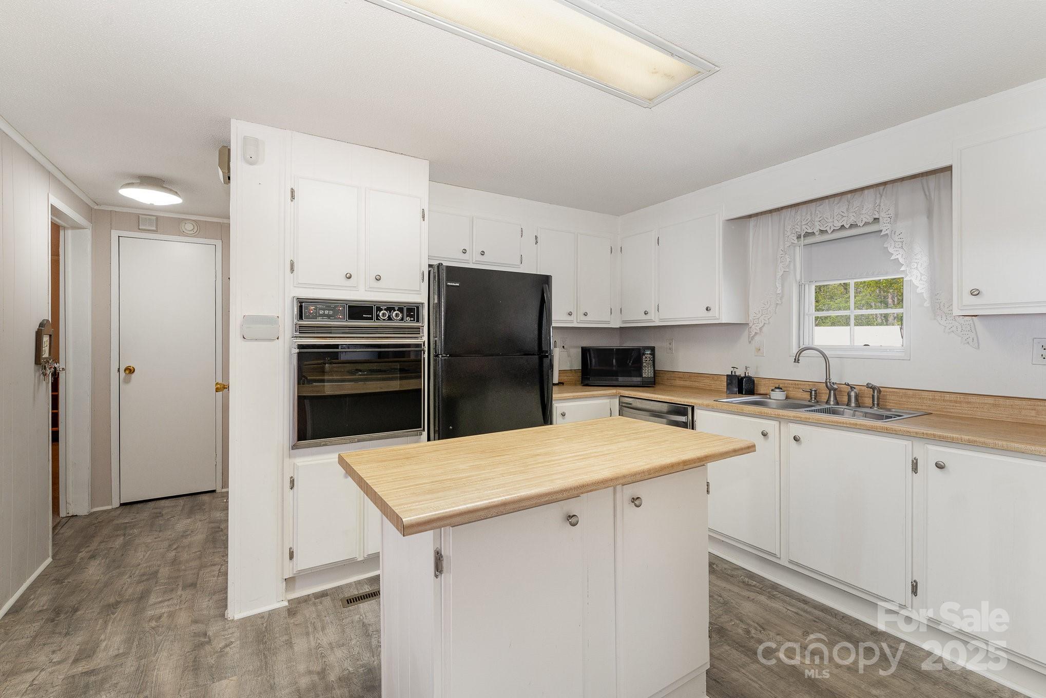 5013 Friendship Circle Road East Bend, NC 27018 - Photo 13 of 31 a kitchen with a sink a stove a refrigerator and a refrigerator