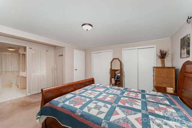 a bedroom with a bed and a mirror