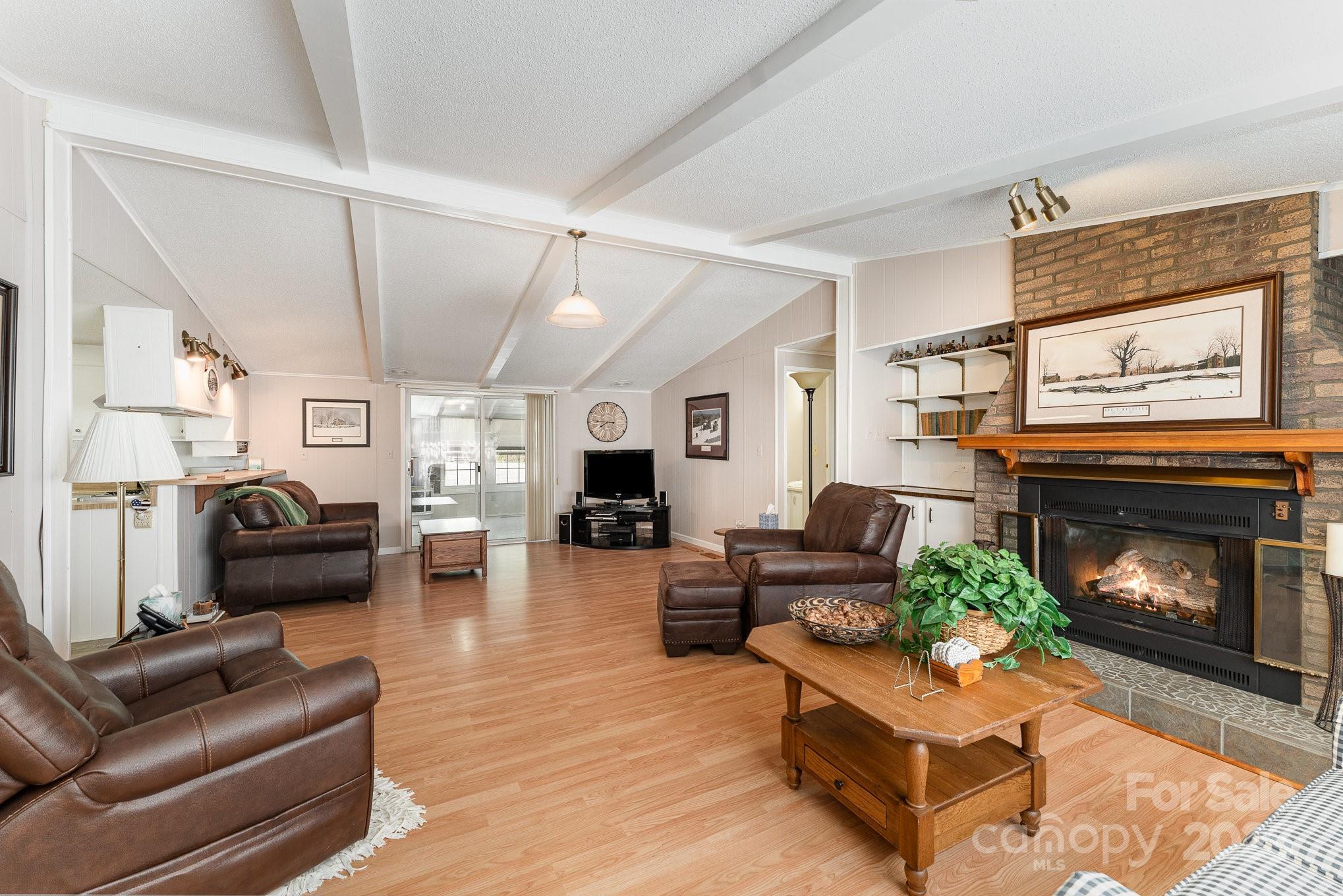 5013 Friendship Circle Road East Bend, NC 27018 - Photo 3 of 31 a living room with furniture a fireplace and a flat screen tv