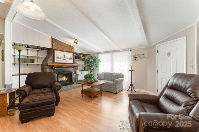 a living room with furniture wooden floor and a fireplace