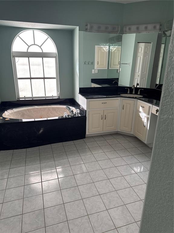 29310 Bryan Way Punta Gorda, FL 33982 - Photo 15 of 30 a view of a kitchen with granite countertop a sink a stove and a microwave