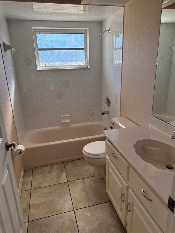 29310 Bryan Way Punta Gorda, FL 33982 - Photo 22 of 30 a bathroom with a granite countertop toilet a sink and bathtub