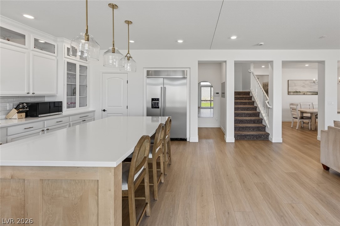 10446 Emerald Rye Street Las Vegas, NV 89183 - Photo 16 of 37 Prepare culinary delights in a modern kitchen with a spacious island, seamlessly flowing into a naturally lit living area.
