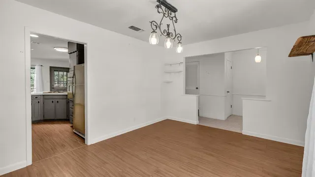 a view of a room with wooden floor and bathroom