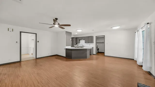 a view of a kitchen with a sink and a refrigerator
