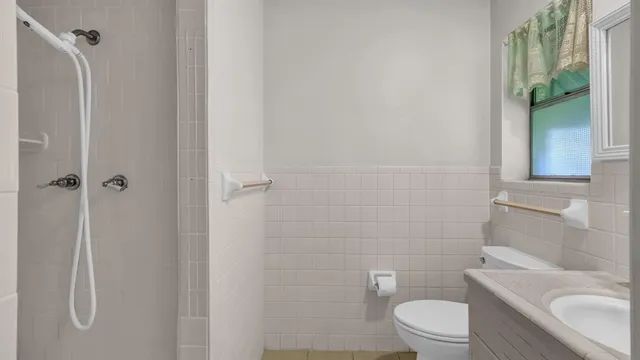 a white toilet sitting next to a bathroom sink