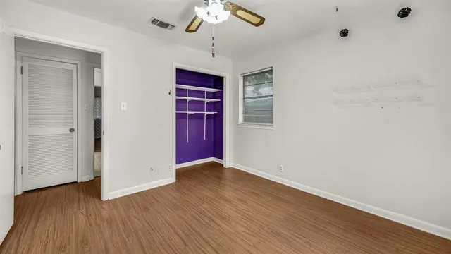 wooden floor in an empty room with a window