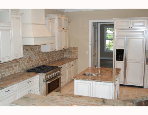 5 Mandalay Road Stuart, FL 34996 - Photo 2 of 3 a kitchen with granite countertop a stove and a sink
