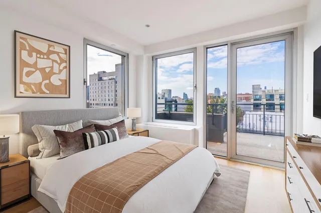 a bedroom with a large bed and a large window