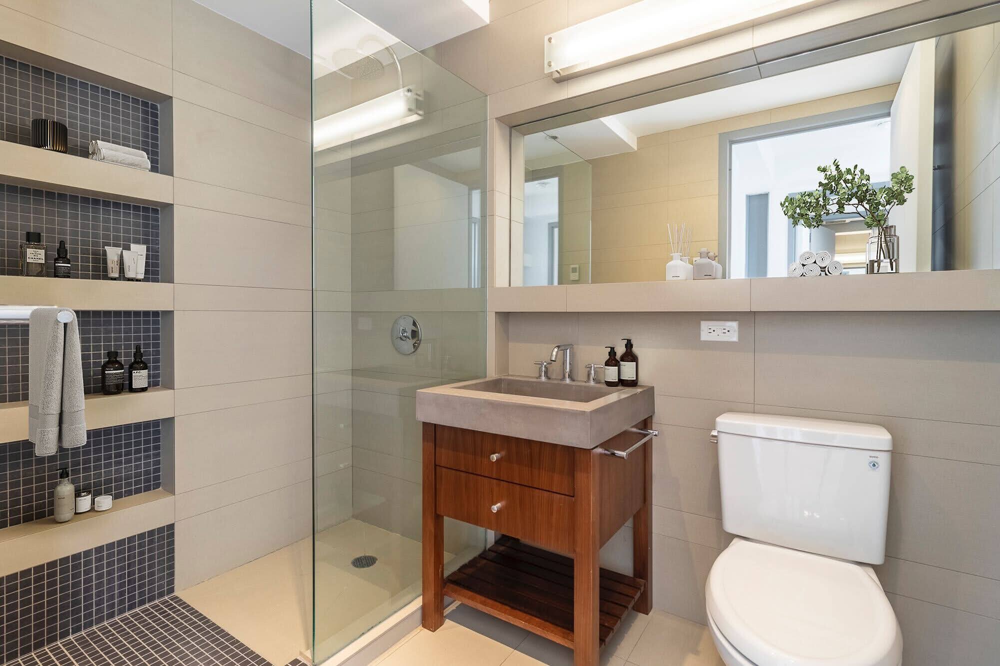 260 North 9th Street, Unit 7A Brooklyn, NY 11211 - Photo 3 of 7 a bathroom with a toilet a sink and glass door