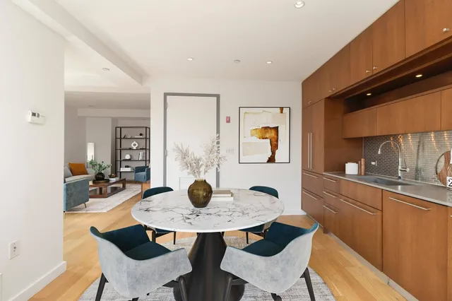 a view of a dining room with a table and chairs