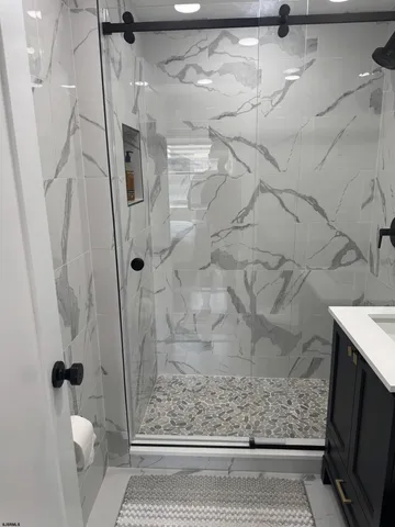 a bedroom with a bed and a flat tv screen on the dresser