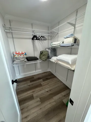 a bedroom with a bed and a night stand