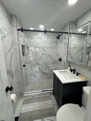 a bathroom with a toilet a sink and shower