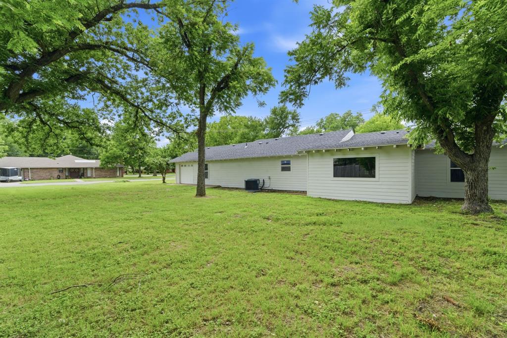 507 Country Club Road Cleburne, TX 76033 - Photo 37 of 39 Expansive green lawn with mature trees providing shade