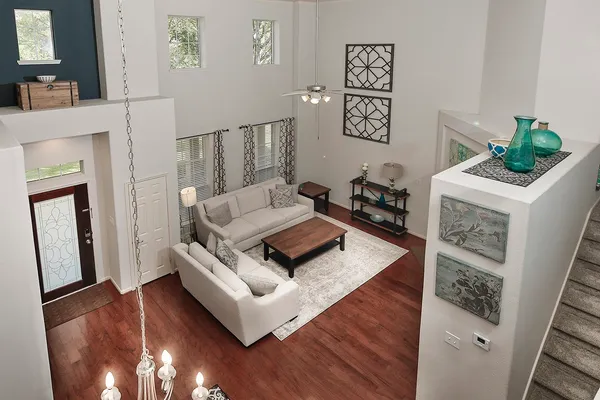 a living room with furniture and a wooden floor