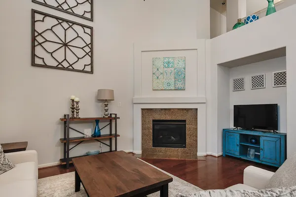 a living room with furniture a flat screen tv and a fireplace