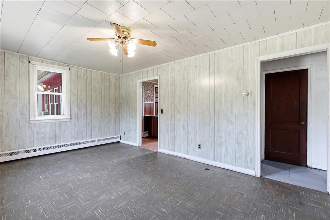 1033 Walt Road Pennsburg, PA 18073 - Photo 5 of 40 Patterned flooring meets wood paneling in this versatile interior space.