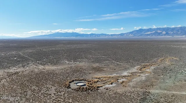 a view of a dry yard with wooden floor and a lake view