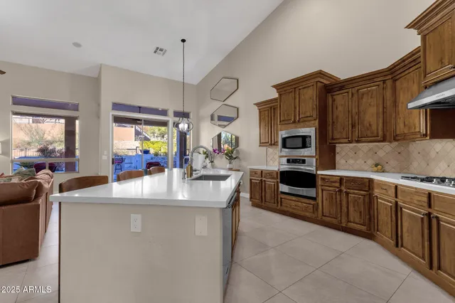 a bathroom with a granite countertop double vanity sink mirror and toilet