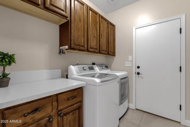 a bedroom with a bed a chandelier and a flat screen television