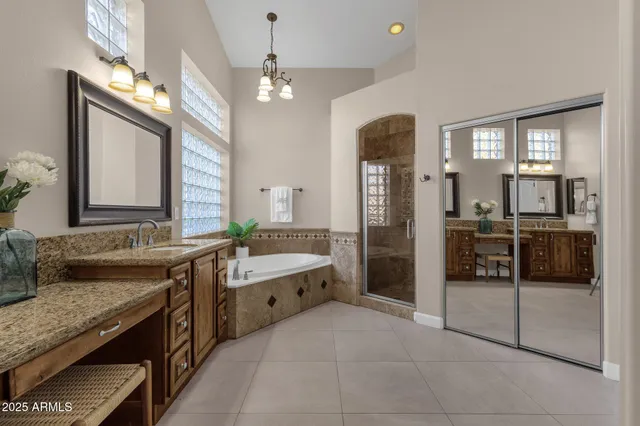 a bathroom with a tub a sink and a shower