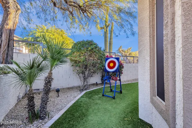 a view of a patio with table and chairs and potted plants