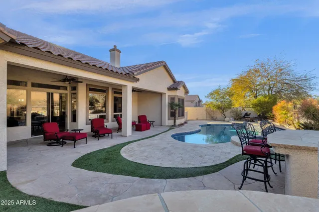 a kitchen with stainless steel appliances kitchen island granite countertop a stove and a sink