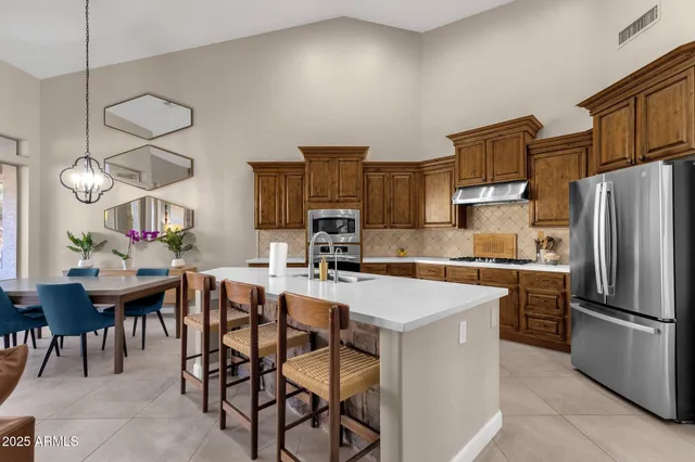 a view of a patio with a dining table and chairs