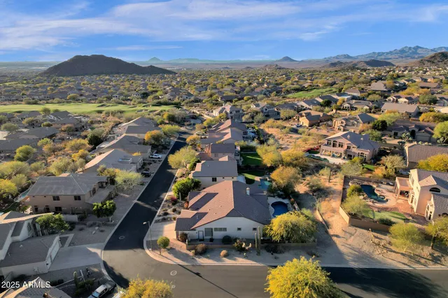 an aerial view of residential houses with outdoor space