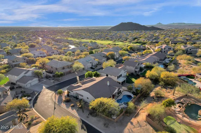an aerial view of residential houses with outdoor space