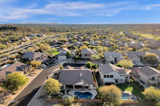 an aerial view of residential houses with outdoor space